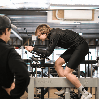 Professional bike fitter observing a person on the guru bike fitting machine