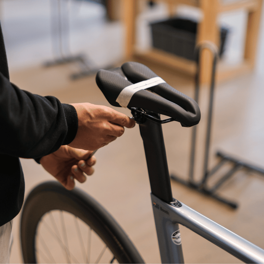 Professional bike fitter adjusting a bike saddle