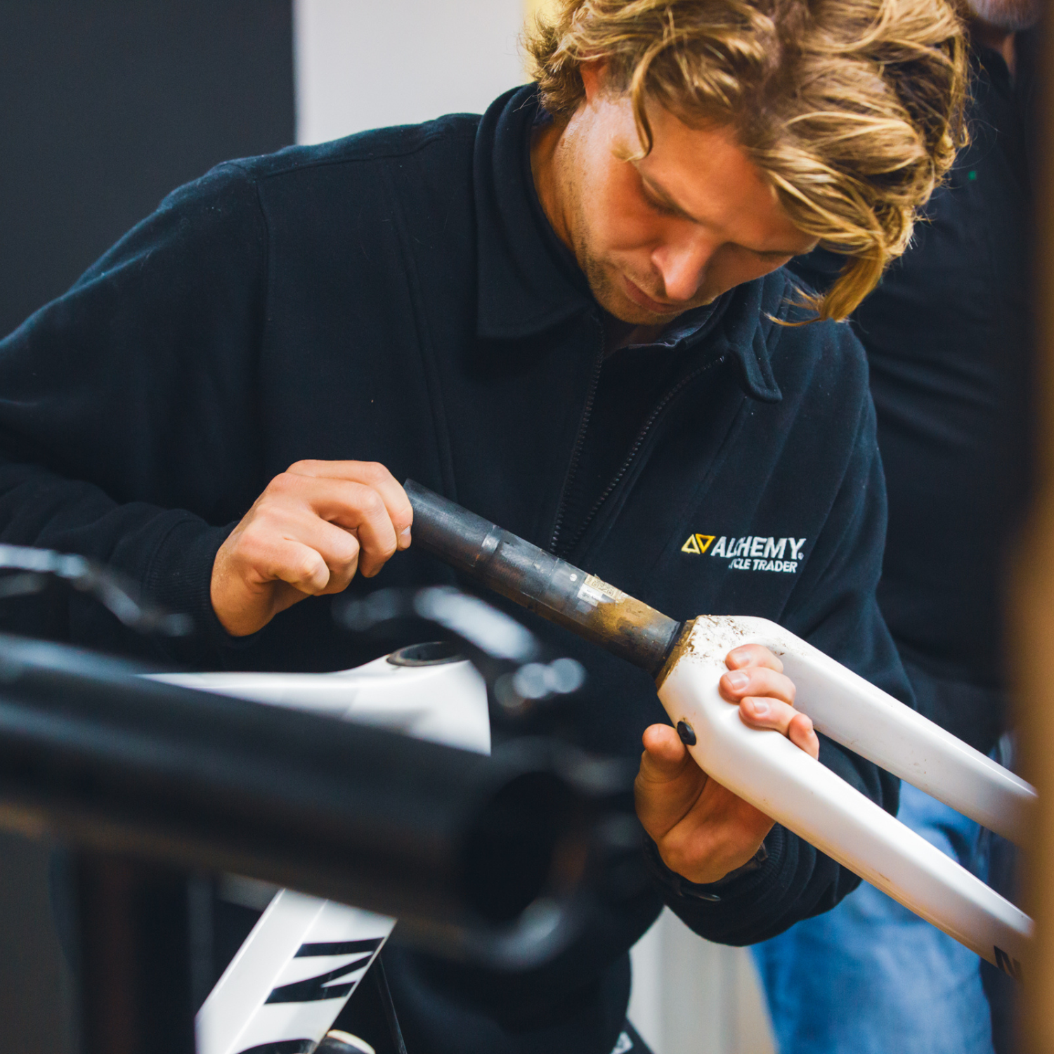 Person inspecting a carbon fibre bike steerer for any damage